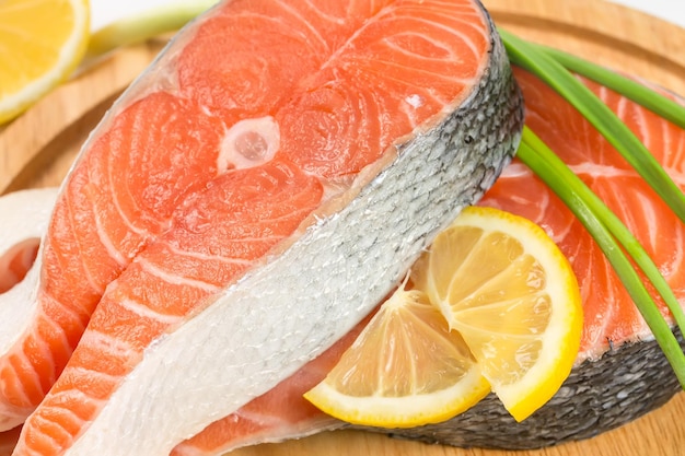 Salmon steak with lemon on a wooden board