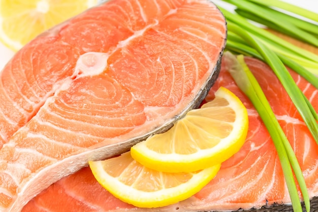 Salmon steak with lemon on a wooden board