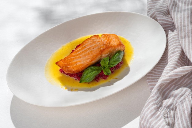 Salmon Steak with red Risotto on white background