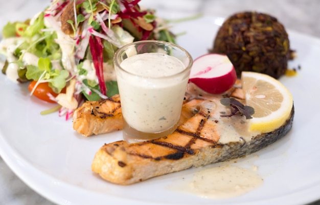 Salmon steak with riceberry and salad