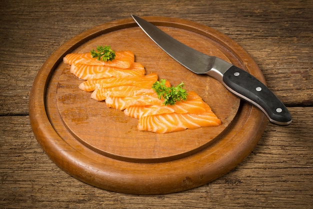 Salmon sushi on cutting board on old wood