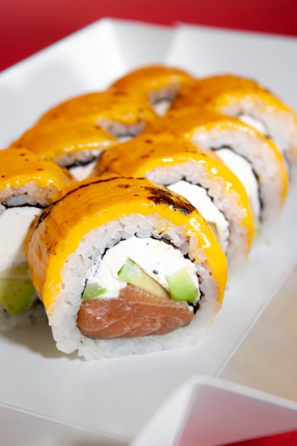 salmon sushi roll with cucumber and philadelphia on white background