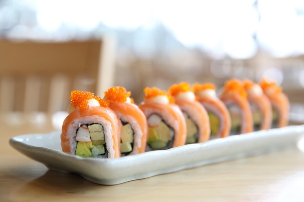 Salmon Sushi rolls on wood background