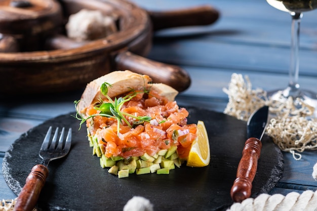 Salmon tartare with capers and pink onion on avocado-2