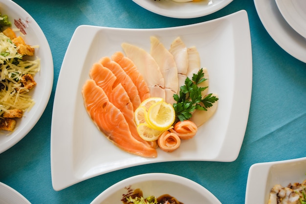 Salmon with lemon and parsley, top view