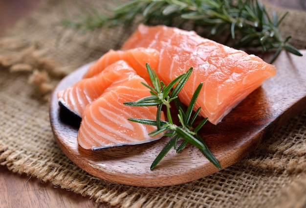 Salmon with rosemary on the wood background