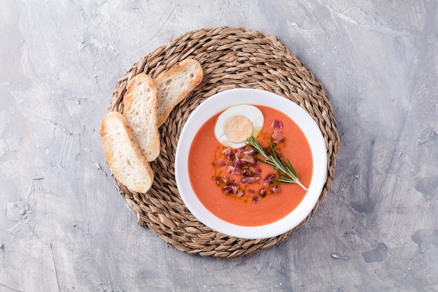 Salmorejo is a tomato soup, Spanish traditional dish. With Ham And Eggs In A Bowl