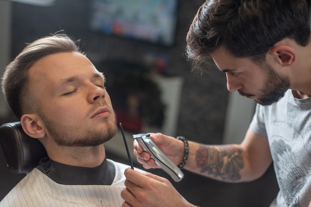 Salon Brutal man sitting in a barber chair