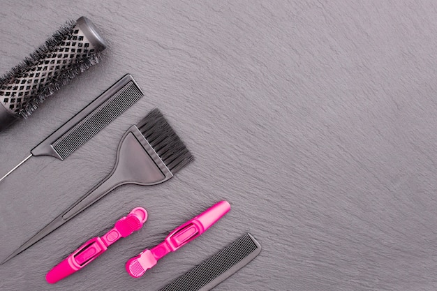 Salon Hairdresser Accessories, pink Comb, application brush,   brashing for cutting hair or colored on a black background