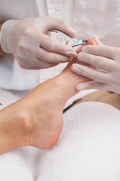 Salon worker using a nail clippers