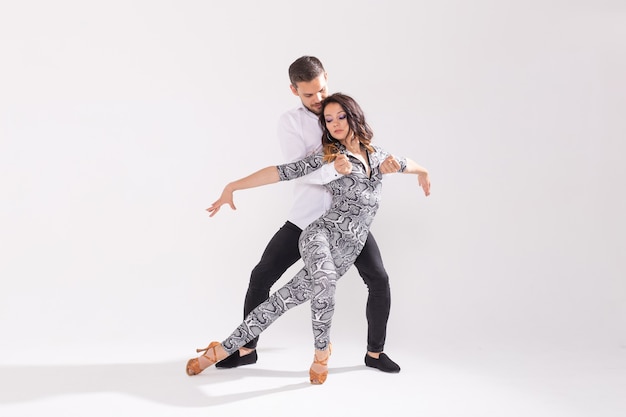 Salsa, kizomba, tango and bachata dancers on white background with copy space. Social dance concept