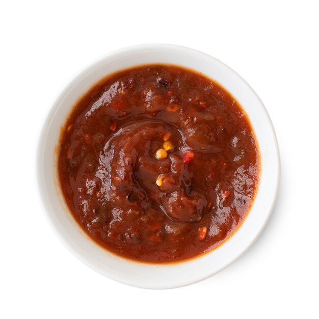 Salsa sauce in a white bowl, isolated on white background. Top view.