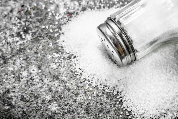 Salt in glass. On rustic background