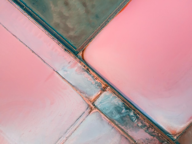 Salt industry with colorful salt and water surface Aerial top down view Abstract nature background