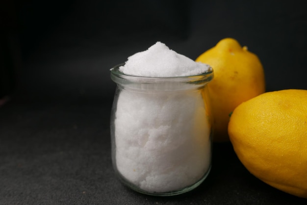 Salt and lemon on black background