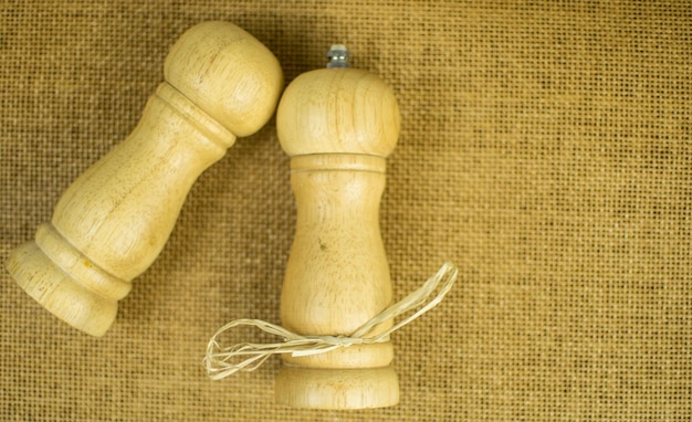 Salt and pepper on a brown background