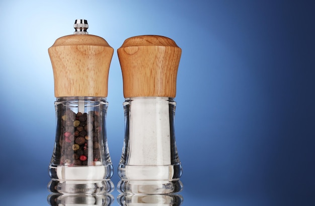 Salt and pepper mills on blue