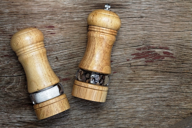 Salt and pepper shakers on a wooden surface