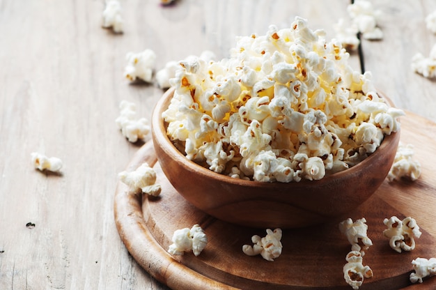 Salt popcorn on the wooden table