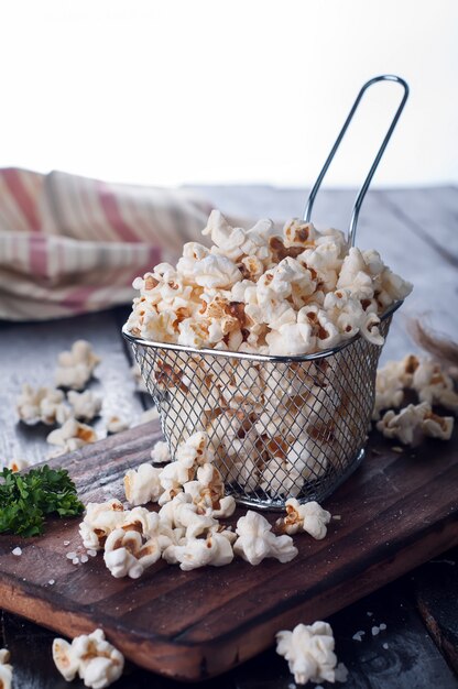 Salt popcorn on the wooden table