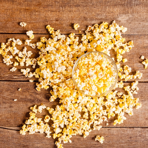 Salt popcorn on the wooden table