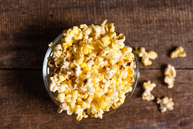 Salt popcorn on the wooden table