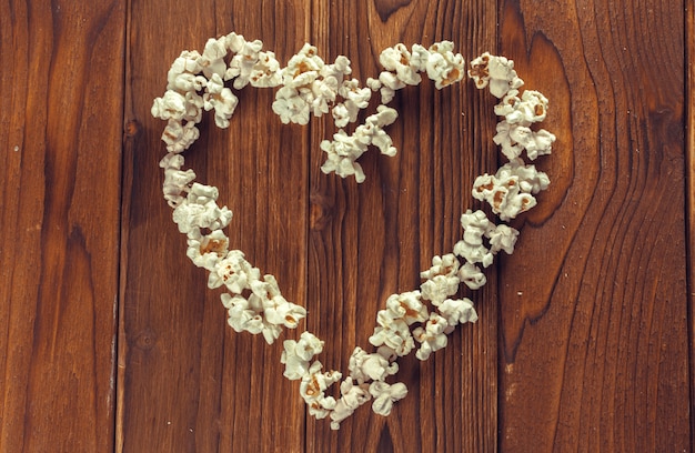 Salt popcorn on the wooden table