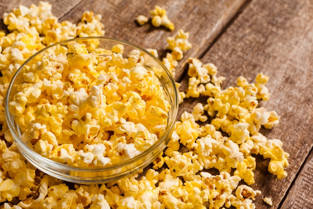 Salt popcorn on the wooden table