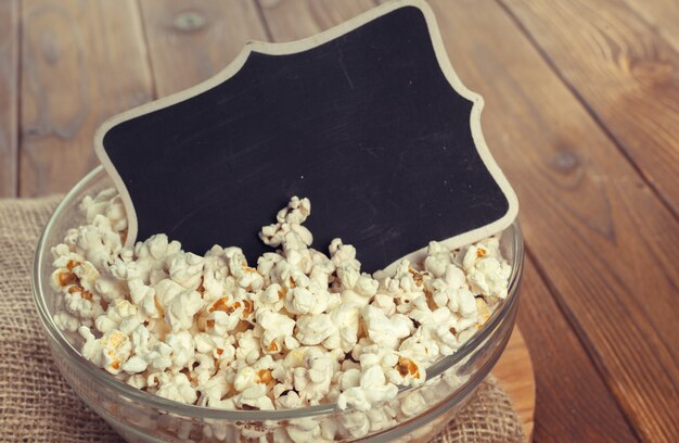 Salt popcorn on the wooden table