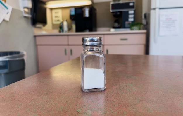 salt shaker on a rustic table casting a soft shadow symbolizing flavor and seasoning in culinary a