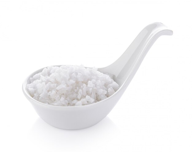 Salt in spoon on white space