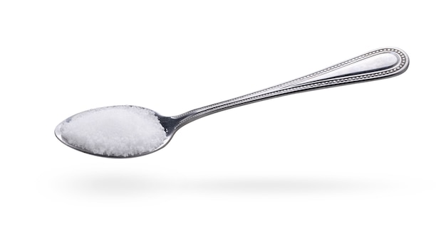 Salt in stainless steel spoon isolated on white background