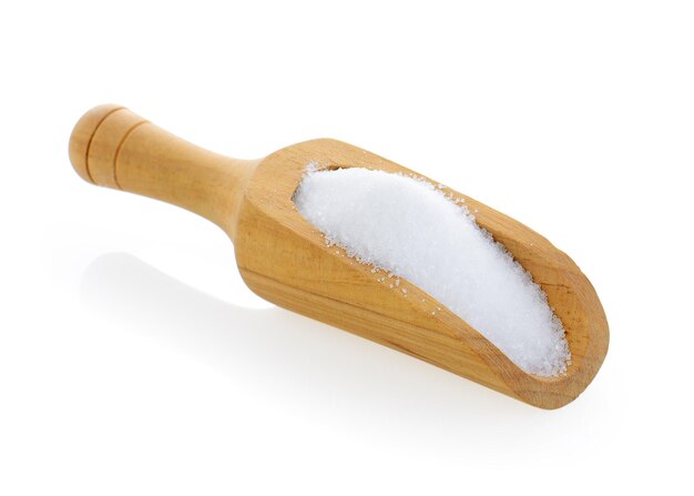 Salt in wooden scoop on white background