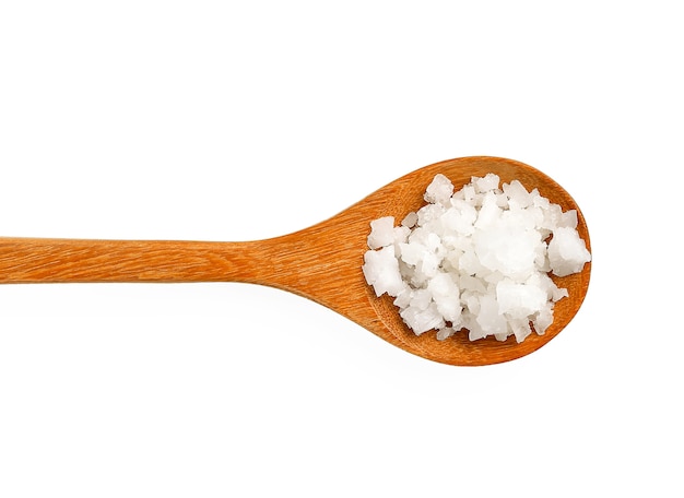 Salt in wooden spoon on white background