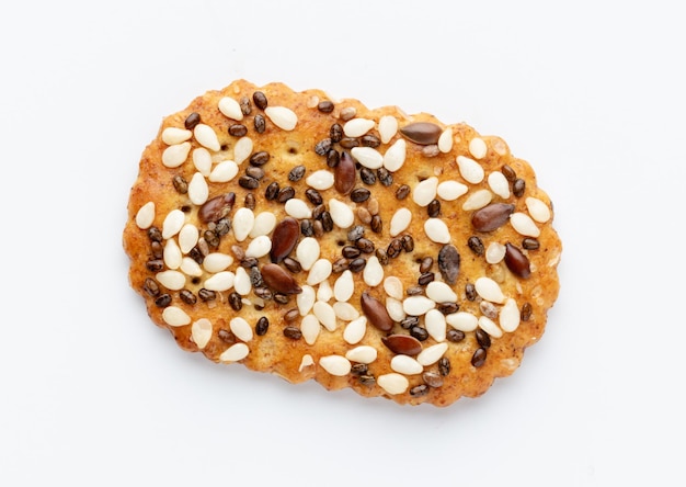 Salted crispy crackers with sesame, sunflower seeds isolated on white background.