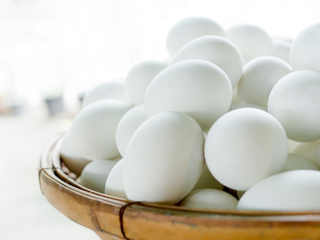 Salted duck egg in bamboo basket on old wooden table in kitchen 