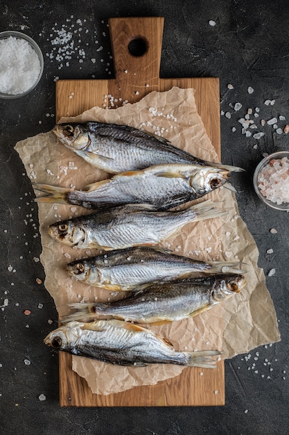 Salted fish on cutting board on the table