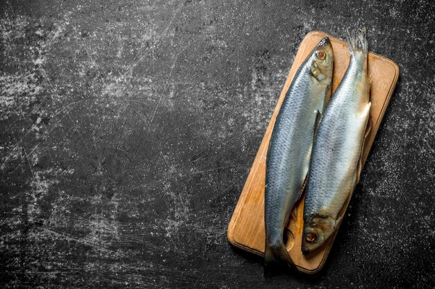 Photo salted herring on a cutting board