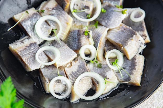 Salted herring in a plate seafood fish healthy meal food snack on the table copy space food