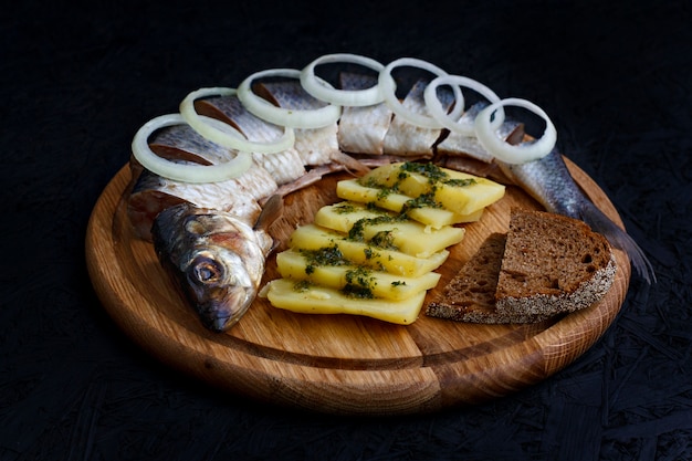 Salted herring with boiled potatoes and green sauce.