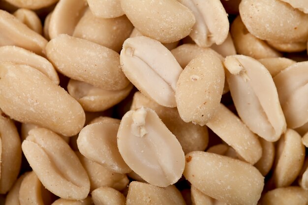 Salted peanuts in a large number of close-up.