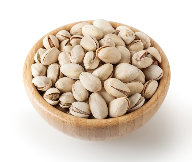 Salted pistachios in wooden bowl isolated on white background with clipping path