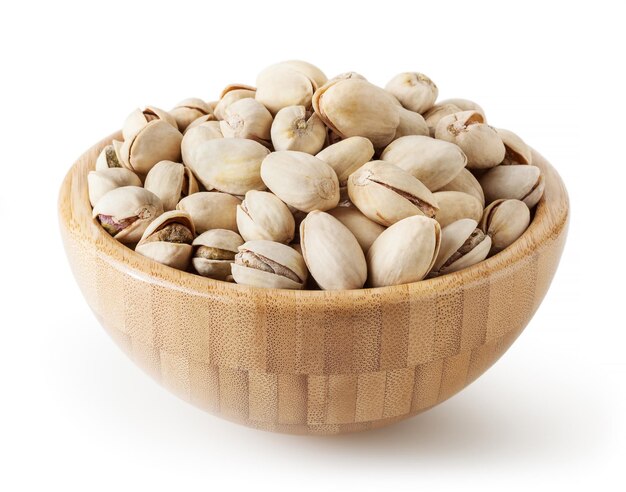 Salted pistachios in wooden bowl isolated on white background with clipping path