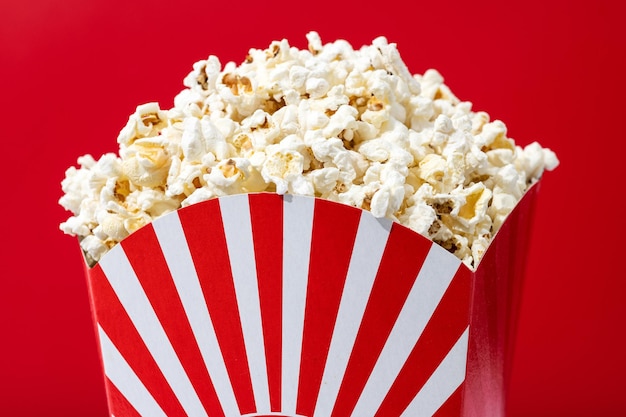 Salted popcorn on red background