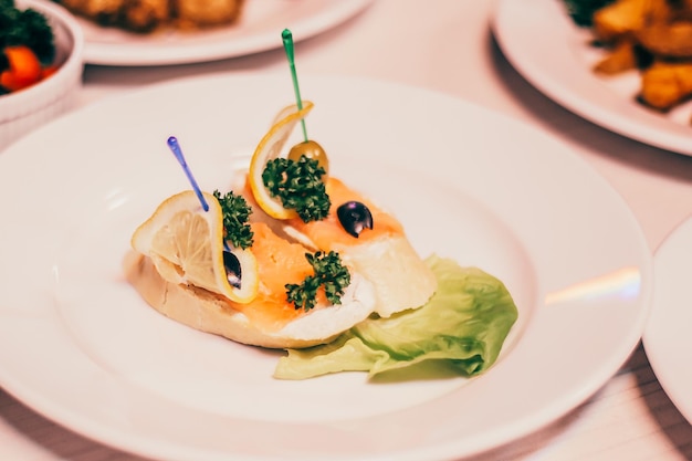 Salted slices of salmon on a fresh loaf and other dishes on the table