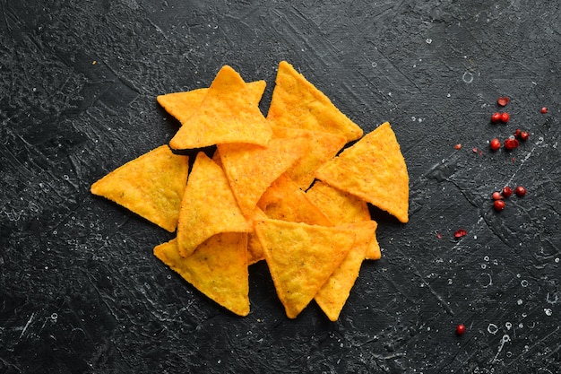 Salty Beer Snacks Salty Nachos On a black stone background