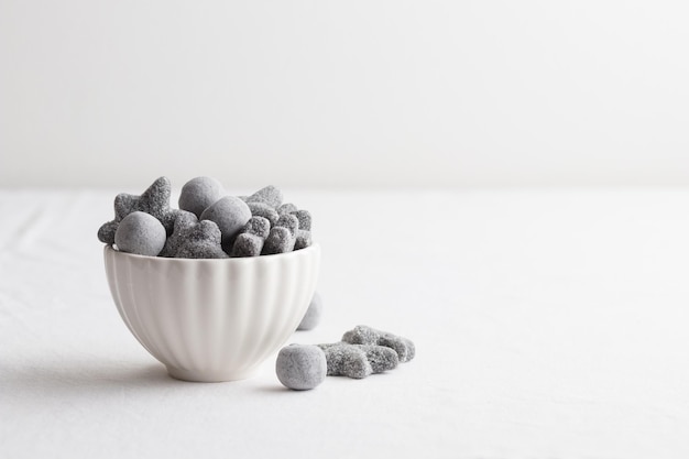 Salty liquorice salmiakki in Finnish in a white bowl