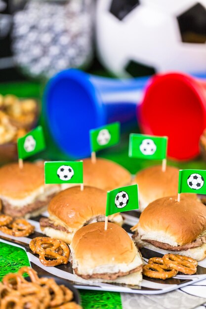 Salty snacks and beer on the table for soccer party.