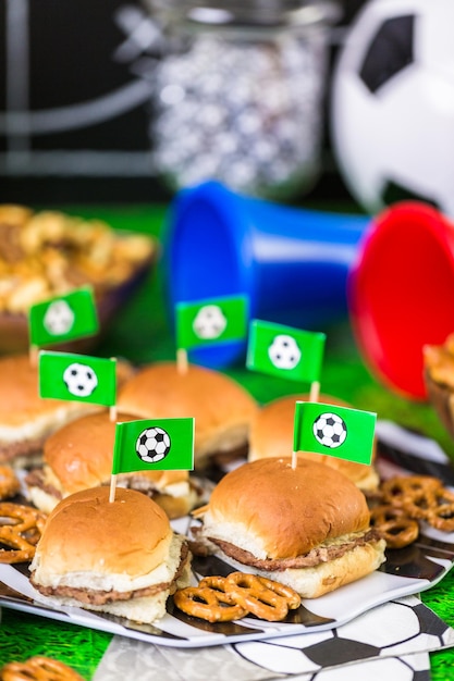 Salty snacks and beer on the table for soccer party.