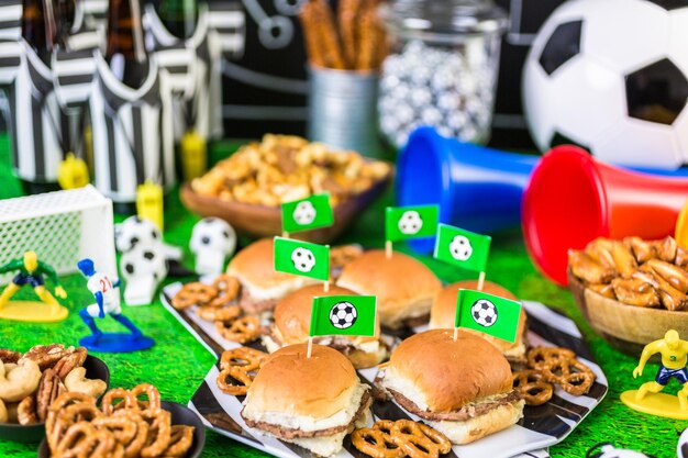 Salty snacks and beer on the table for soccer party.